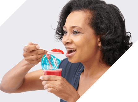 Older female patient prepares to eat high protein gelatin, a nutritional supplement to build muscle mass