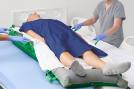 Meta Gloved caregiver hands dispense ISP antifungal powder to patient’s foot.