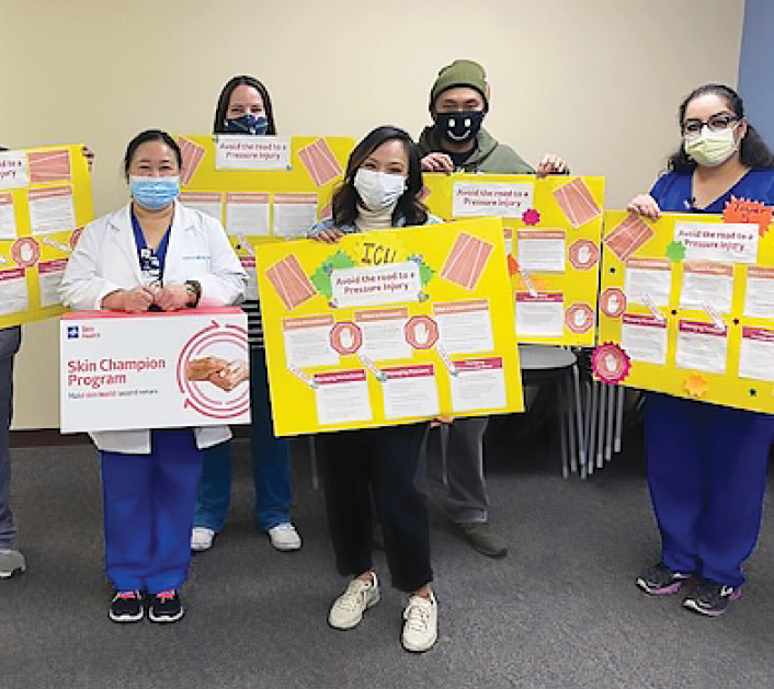 BAN_Staff Members of Desert Springs Skin Champion team holding up posters they created