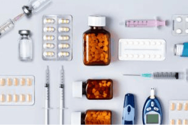 pharm-offering medications in bottles and foil packages, syringes, glucose meter, asthma inhaler, all arranged artistically
