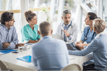 prime-vendor Surgery center staff and reps sitting and conversing around a table