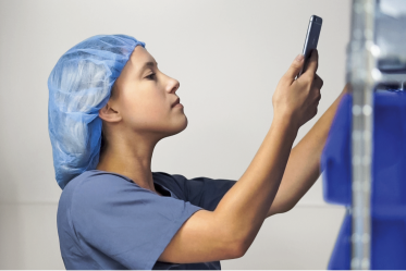 reduce-picking-time surgery center worker checking inventory with a handheld device