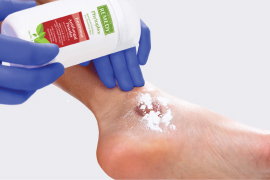 Caregiver’s gloved hands opening up boot to show its lining