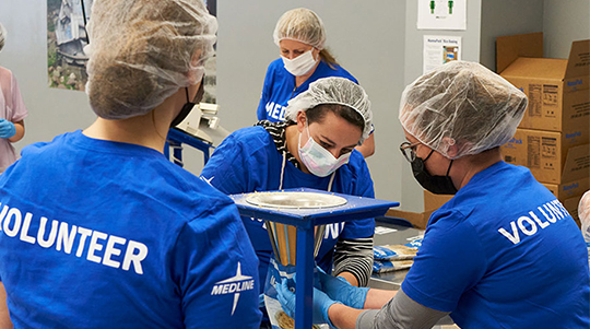 Medline employees volunteering at Feed My Starving Children
