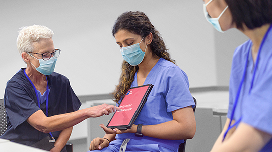 Clinician showing caregiver Skin Champion information