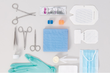 Mulitiple items that makeup a procedure kit are on a table.
