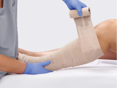 HeelMedix Advanced Heel Protector with instructional toe/heel printing applied to patient’s heel in hospital bed