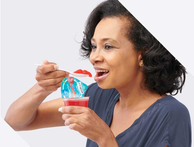 Older female patient prepares to eat high protein gelatin, a nutritional supplement to build muscle mass
