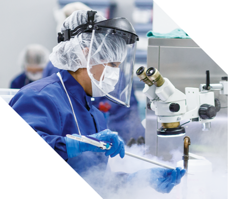 Technician in sterile mask reprocesses a device.