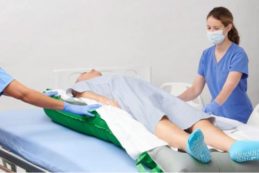 Female clinician carefully checks test tube in lab