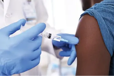 vaccines-min patient receiving injection to left arm