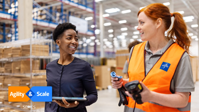 Warehouse staff discuss inventory on the floor