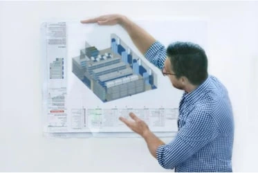 Man presents a blueprint of new site