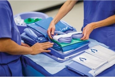 Workers pack a clinical kit on the line