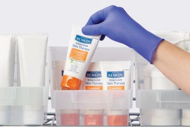 Product-label Clinician pulls Remedy Calazime off of tub on supply room shelf instead of competing skin products