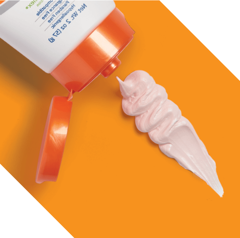Hand holds Calazime tube in front of other competing packages of zinc oxide cream 