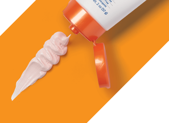 zinc-oxide-cream Hand holds Calazime tube in front of other competing packages of zinc oxide cream