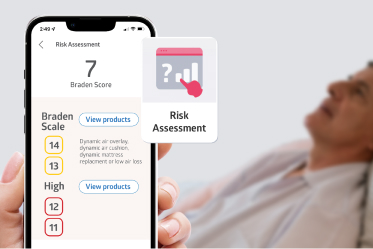 promote-PI-prevention Caregiver uses risk assessment tool at bedside of reclined resident