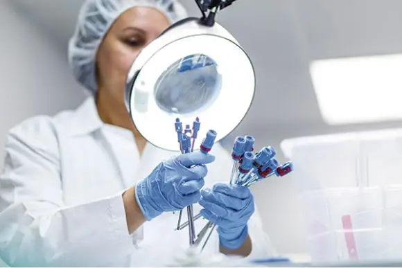 quality-management-min Woman inspects a product to ensure manufacturing quality and uphold Medline’s 99.98% defect free rate.