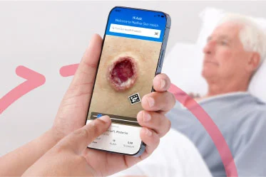 Caregiver holds phone and reviews a photo of a wound