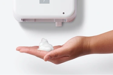 Hand showing dispensed hand sanitizer from dispenser