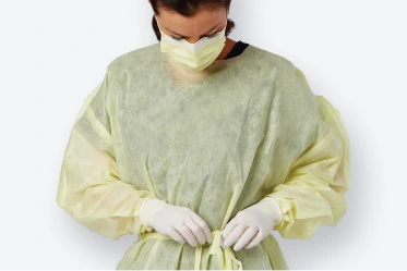 Healthcare worker wearing face mask, gown and gloves