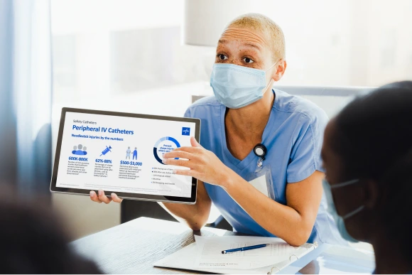Clinician using tablet to teach staff about peripheral IV catheters