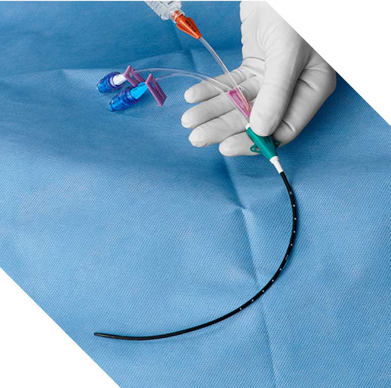 Vantex CVC in gloved hand over blue sterile barrier