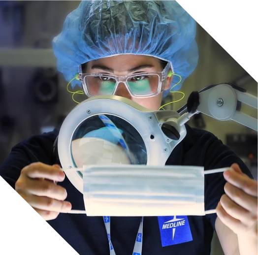 Quality control expert inspecting Medline facemask