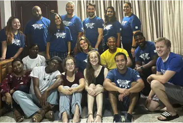 A group of young Global Health volunteers pose together.