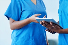 business_solutions_image4 a tablet being held by a caregiver with no faces visible