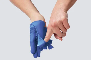 customized-solutions Clinician removes gloves from hands