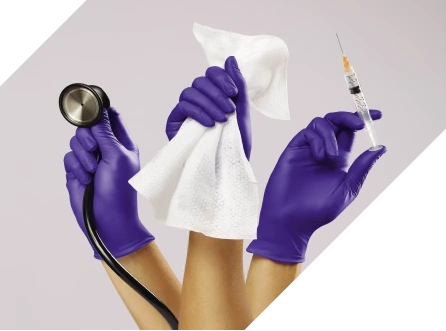 exam-gloves-hero-banner Three gloved hands, holding a stethoscope, cloth and syringe respectively