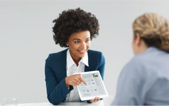 ltc_request_sample_image A female rep presenting information on her tablet with another person