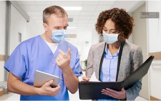ppe-product-recommendation Clinician and supply rep looking at binder