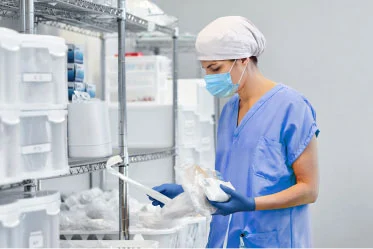 streamlined-supply-chain Clinician pulls product off of a supply shelf